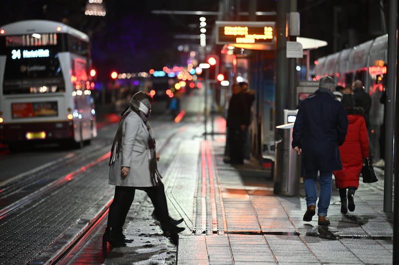 People on the near-deserted Princes Street in Edinburgh after all outdoor events including the street party and fireworks display planned for Edinburgh’s New Year were cancelled due to bad weather.