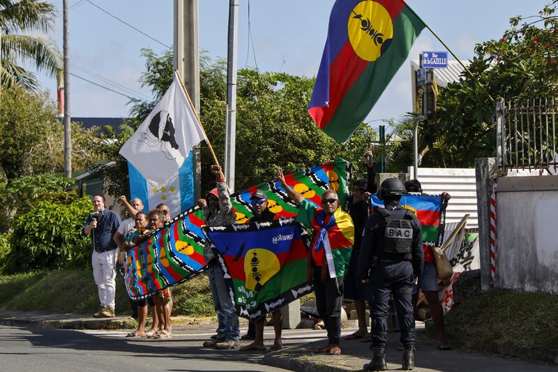 People demonstrated as Mr Macron’s motorcade drove past in Noumea (Ludovic Marin/Pool Photo via AP)