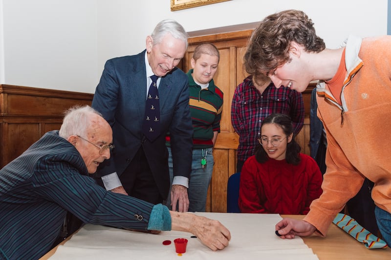 Bill Steen, far left, with Peter Downes, playing tiddlywinks with current Cambridge University staff and students