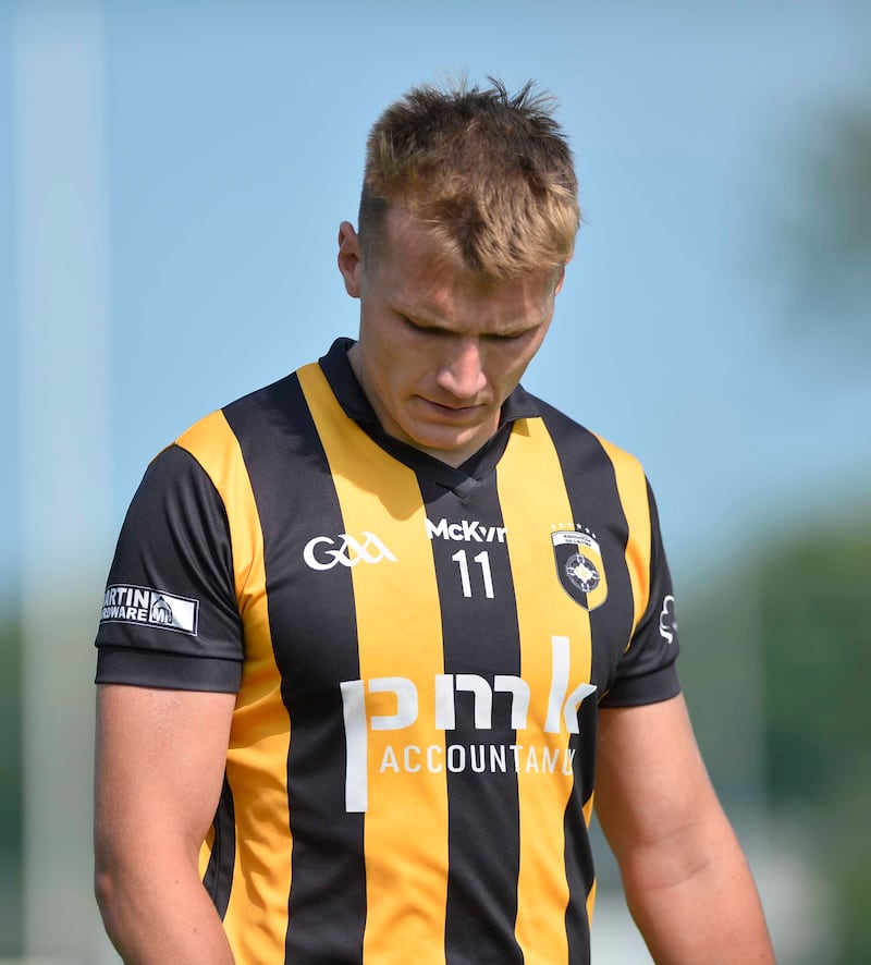 Rian O'Neill in a Crossmaglen jersey looking at the ground