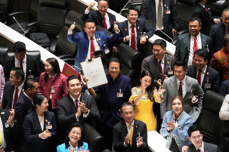 Pheu Thai party legislators celebrate after Thailand’s parliament elected the party’s leader Paetongtarn Shinawatra as the country’s new prime minister (Sakchai Lalit/AP)