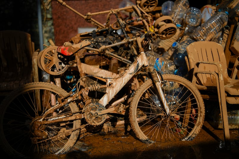 Mud covers a bicycle and various belongings in Valencia, Spain (Manu Fernandez/AP)