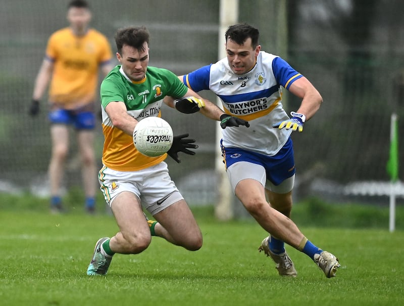 Carrickmore's Sean Donnelly is challenged by Eoin Kelly of Errigal Ciaran.