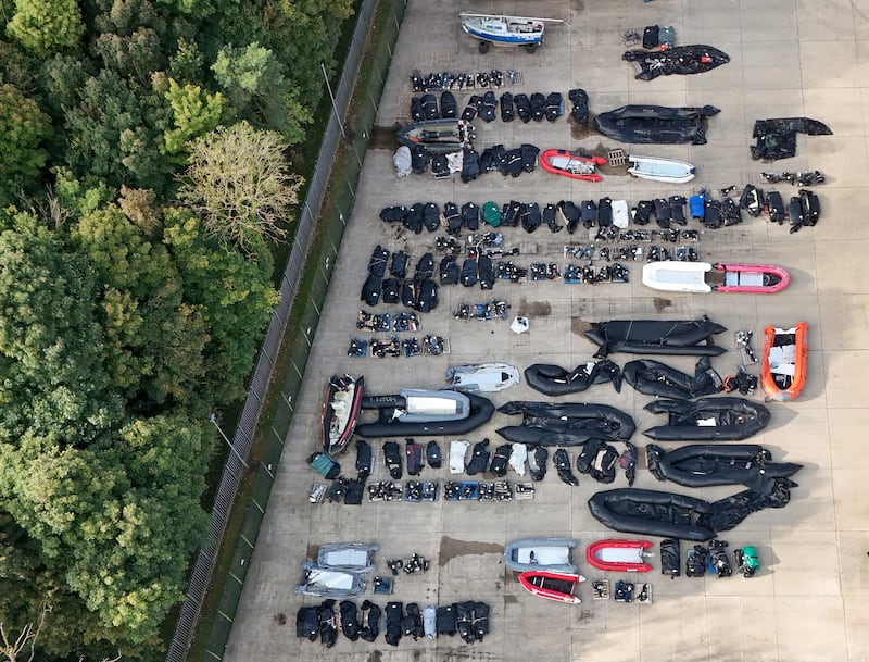 Small boats and outboard motors used by people thought to be migrants to cross the Channel in storage at a warehouse facility in Dover, Kent