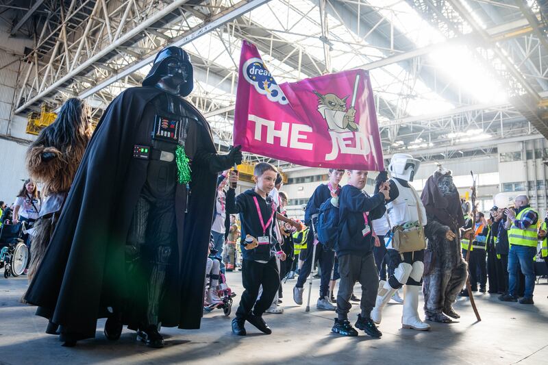 Children from the Jedi group parade with Darth Vader