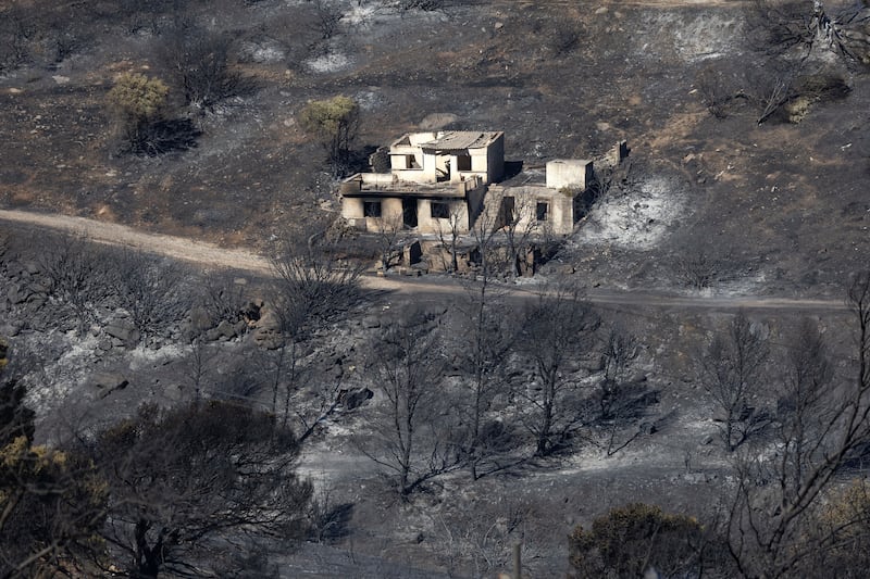 A destroyed home in an area of scorched earth near Athens (Yorgos Karahalis/AP)