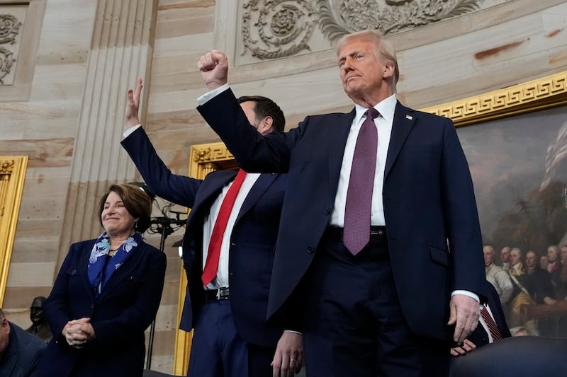 President Donald Trump gestures as he is joined on stage by vice president JD Vance after being sworn in as the 47th president of the United States (Morry Gash, Pool/AP)