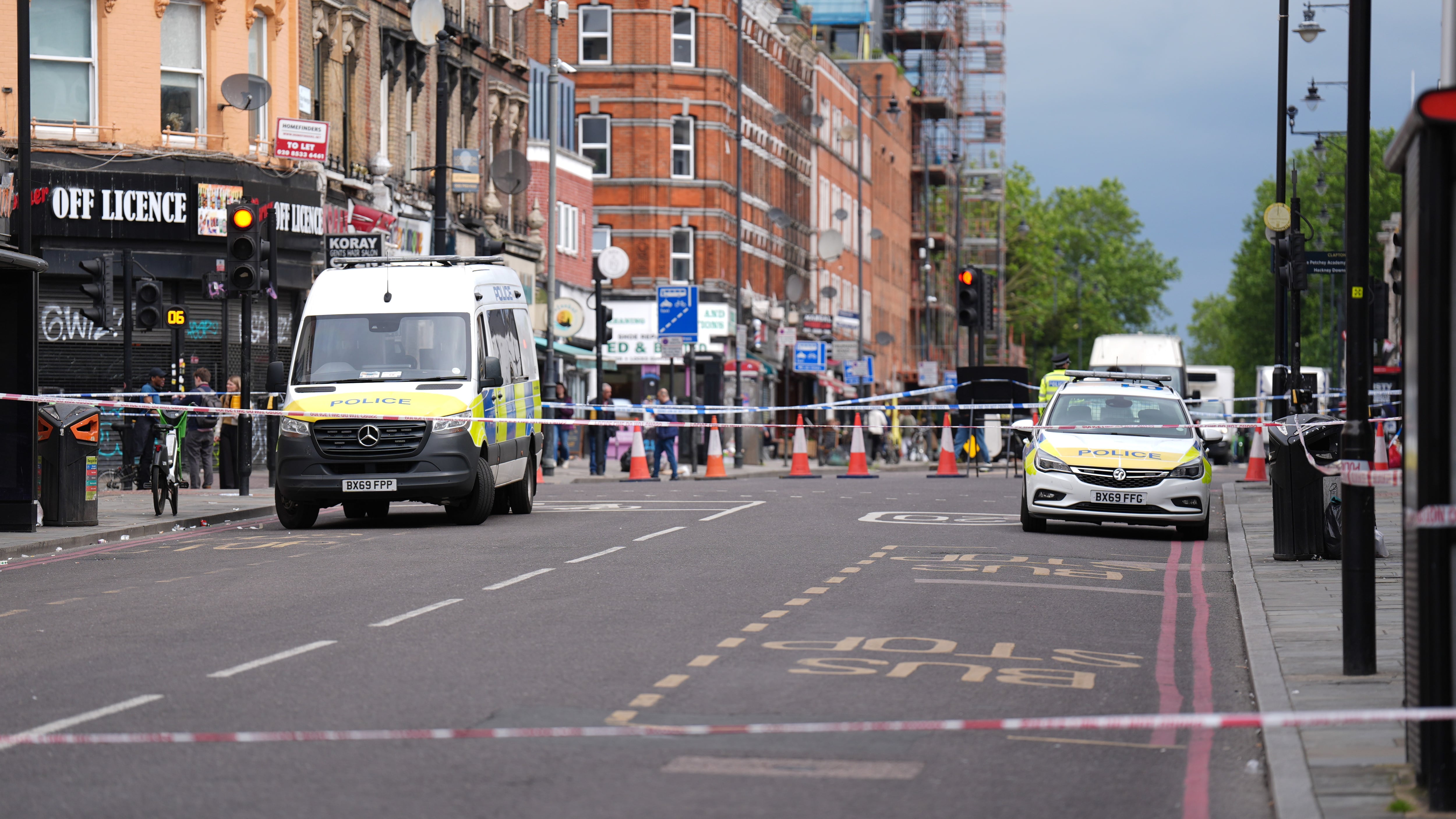 Police at the scene of the shooting in Kingsland High Street, Hackney, east London