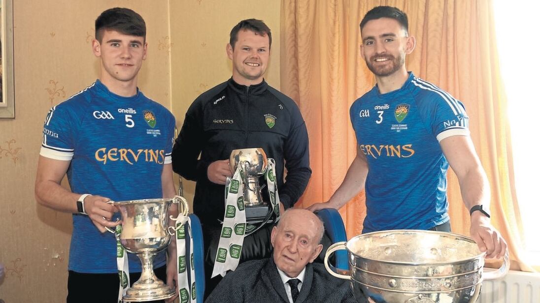 Coalisland's four All-Ireland winning captains. Seated is Eddie Devlin, captain of the county's trailblazing minors in 1947. Behind him, Peter Donnelly, who led them at the same grade in 2001. On the right, Padraig Hampsey, 2021 All-Ireland senior winning skipper, and on the other side is Niall Devlin, captain of the 2022 All-Ireland U20 team.