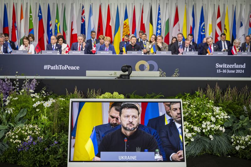 Ukrainian President Volodymyr Zelensky is seen on the screen during the plenary session of the peace summit in Switzerland (Urs Flueeler/Keystone/AP)
