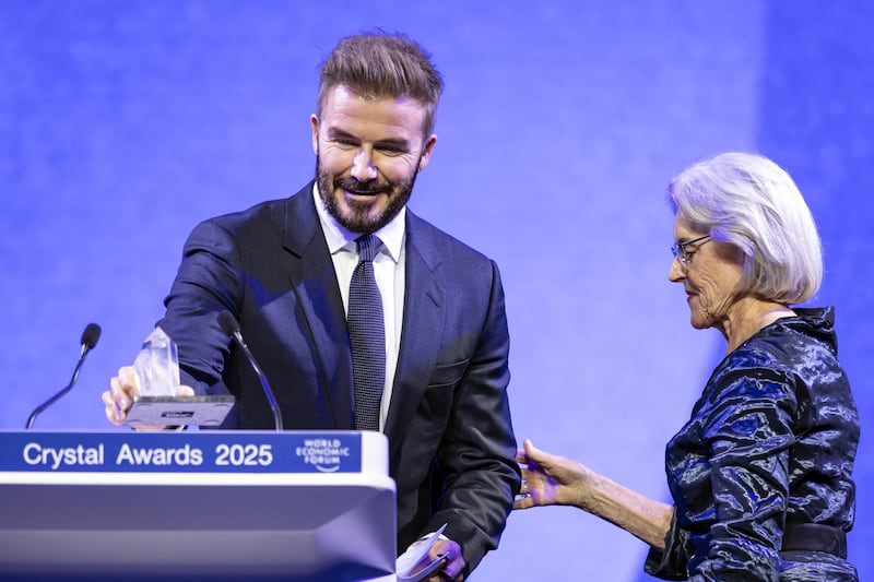 David Beckham prepares to speak after receives a Crystal Award from Hilde Schwab (Michael Buholzer/Keystone via AP)