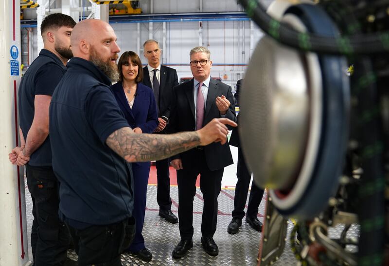 Labour leader Sir Keir Starmer talks to members of staff during a visit to Rolls-Royce in Derby