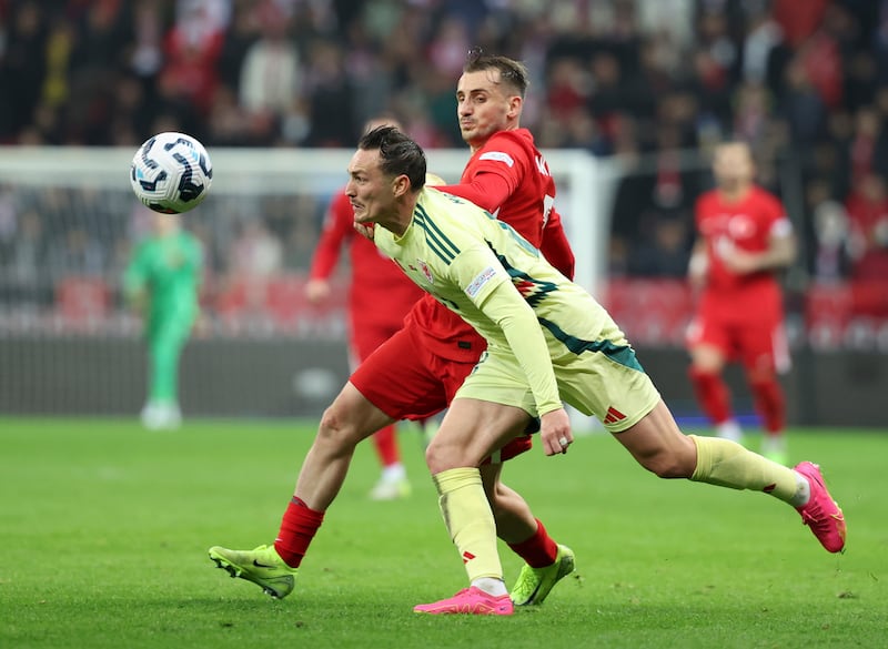 Connor Roberts, front, fights for the ball with Turkey’s Kerem Akturkoglu in their Nations League battle (Huseyin Yavuz/Dia Photo via AP)