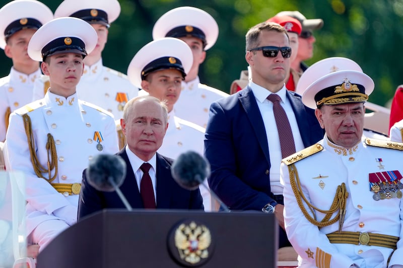 President Vladimir Putin delivers his speech flanked by Russian Navy Commander-in-Chief Admiral Alexander Moiseyev, right, during the Navy Day parade in St Petersburg (Dmitri Lovetsky/Pool/AP)