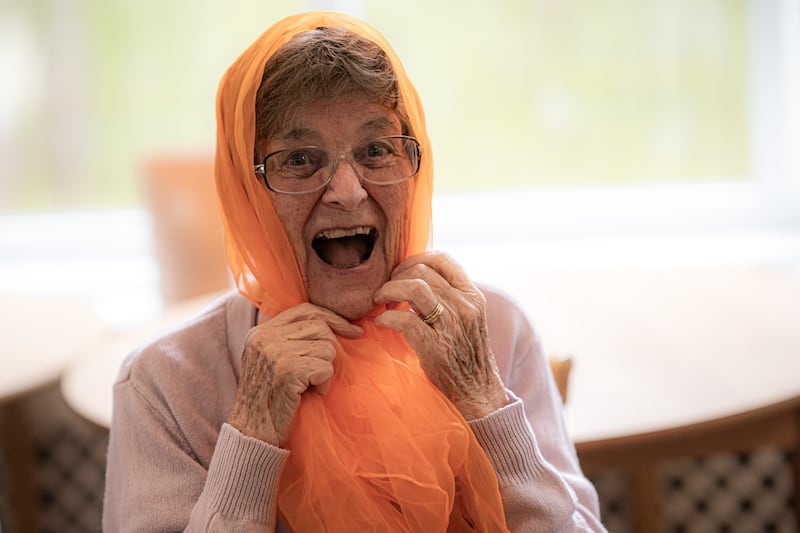 Betty Bealey, 87, plays around with an orange scarf