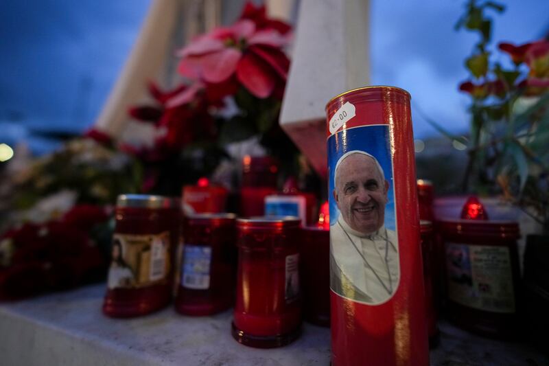 Candles, one showing a photo of Pope Francis, in front of the Agostino Gemelli Polyclinic in Rome (Andrew Medichini/AP)