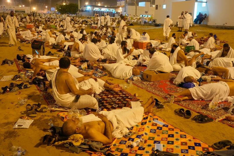 Muslim pilgrims rest in Muzdalifah, near the holy city of Mecca, on the second day of the annual Hajj pilgrimage (Rafiq Maqbool/AP)