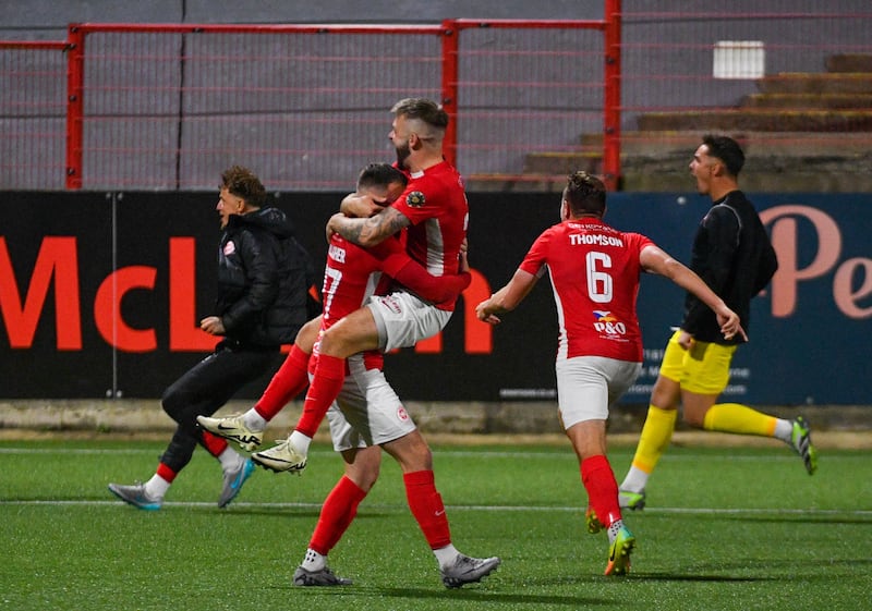 A group of football players celebrating following a penalty shoot-out win