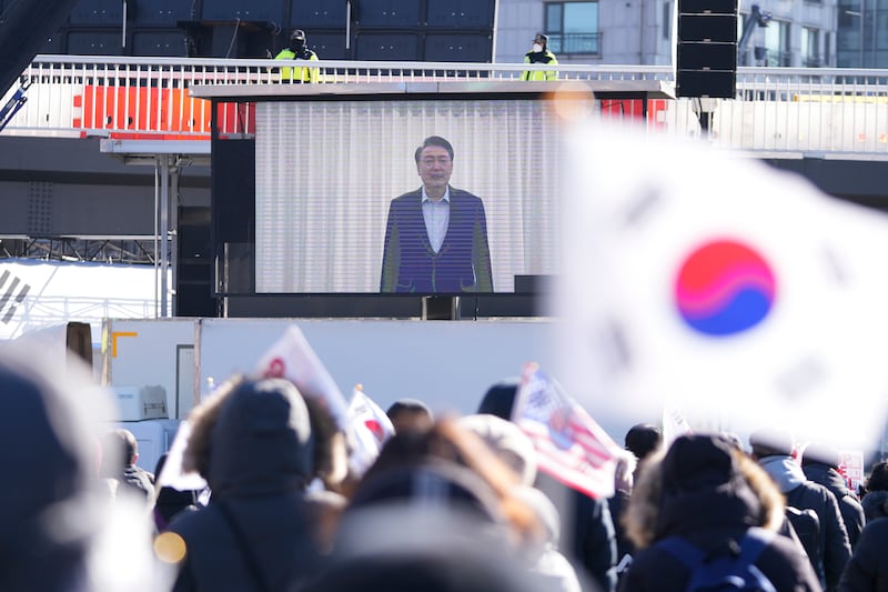 A screen displays footage of impeached South Korean President Yoon Suk Yeol as supporters stage a rally to oppose his impeachment near the presidential residence in Seoul (Lee Jin-man/AP)