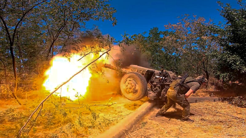 A Russian soldier fires from a D-30 howitzer towards Ukrainian positions in an undisclosed location in Ukraine (Russian Defence Ministry Press Service via AP)