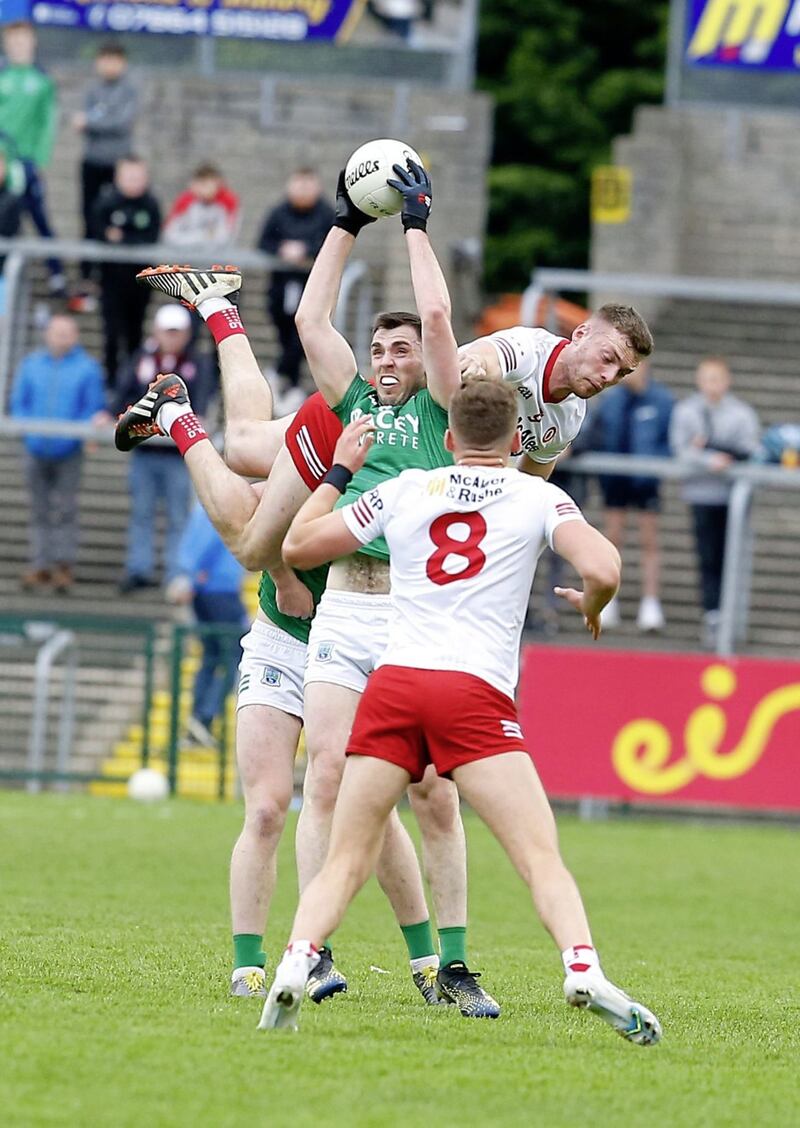 Fermanagh's Ryan Jones takes a catch under pressure from Tyrone midfield duo Brian Kennedy and Conn Kilpatrick (8) in the Ulster SFC preliminary round. <br />Pic Philip Walsh