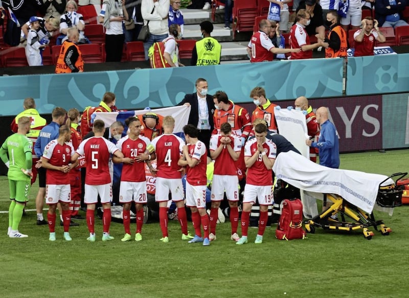 The Danish players formed a wall around Christian Eriksen as he received treatment after suffering a cardiac arrest during Saturday&#39;s Euro 2020 game against Finland. Picture by PA 