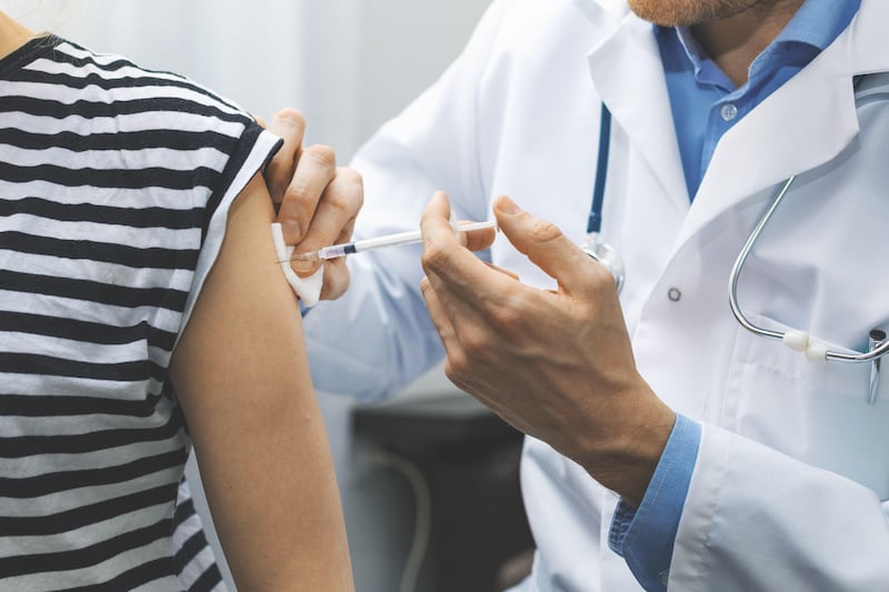 Doctor giving a patient a flu vaccine