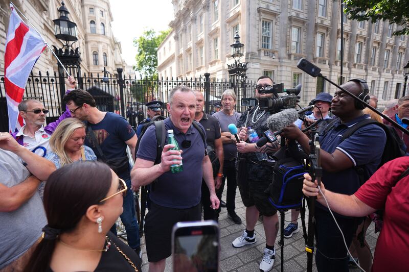 Protesters gathered outside Downing Street in London after Robinson was arrested