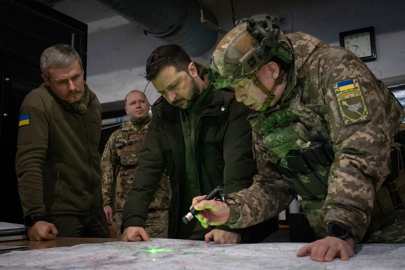 Ukrainian President Volodymyr Zelensky and Colonel General Oleksandr Syrsky, right, look at a map during their visit to the front line city of Kupiansk (Efrem Lukatsky/AP)