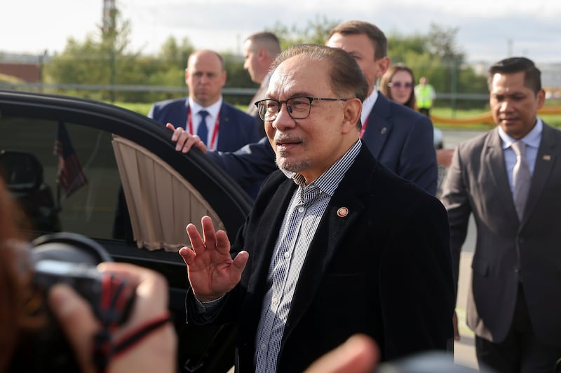 Malaysia’s Prime Minister Anwar Ibrahim gestures as he speaks upon his arrival at the International Airport in Vladivostok, Russia (Yulia Egorova/AP)