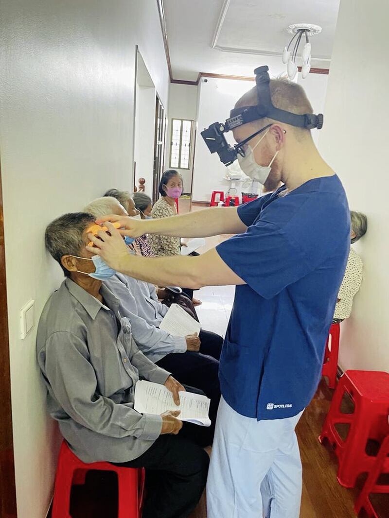 Shane Higgins gets to work at the sight clinic in Phnom Penh 