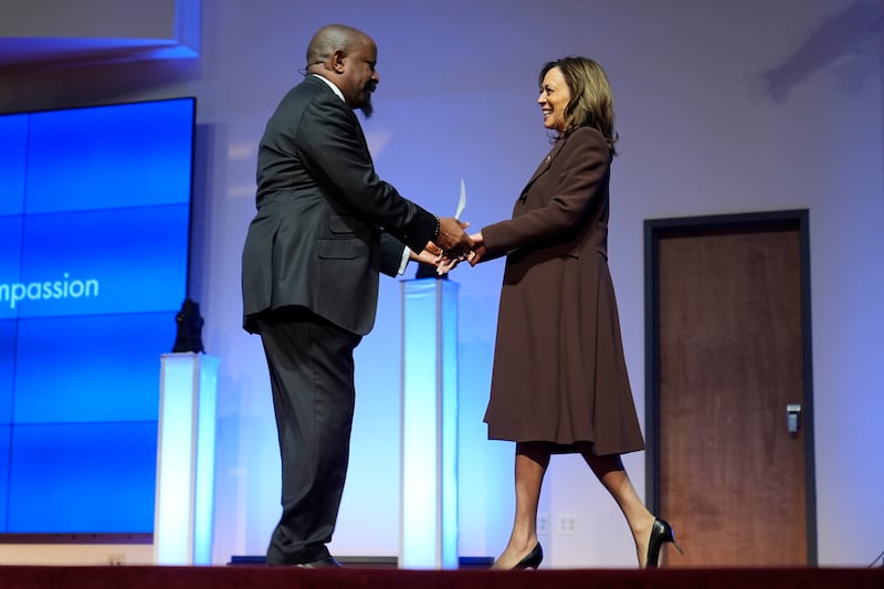 Pastor W Lonnie Herndon greets Kamala Harris during a service at the Church of Christian Compassion in Philadelphia (Susan Walsh/AP)