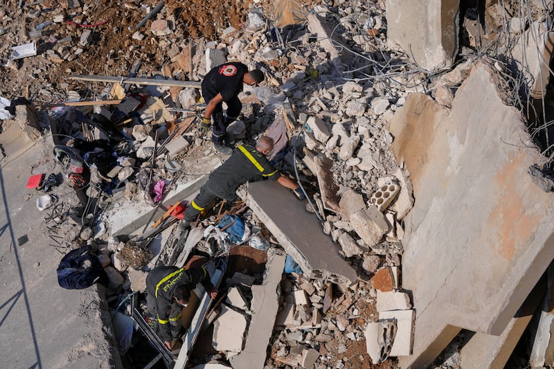 Rescuers search for victims in Barja (Hassan Ammar/AP)