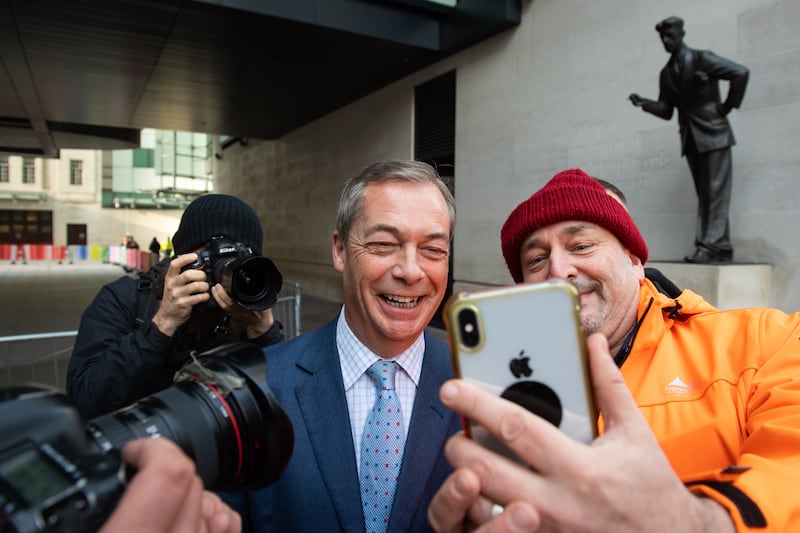 Nigel Farage poses for a photograph with a supporter