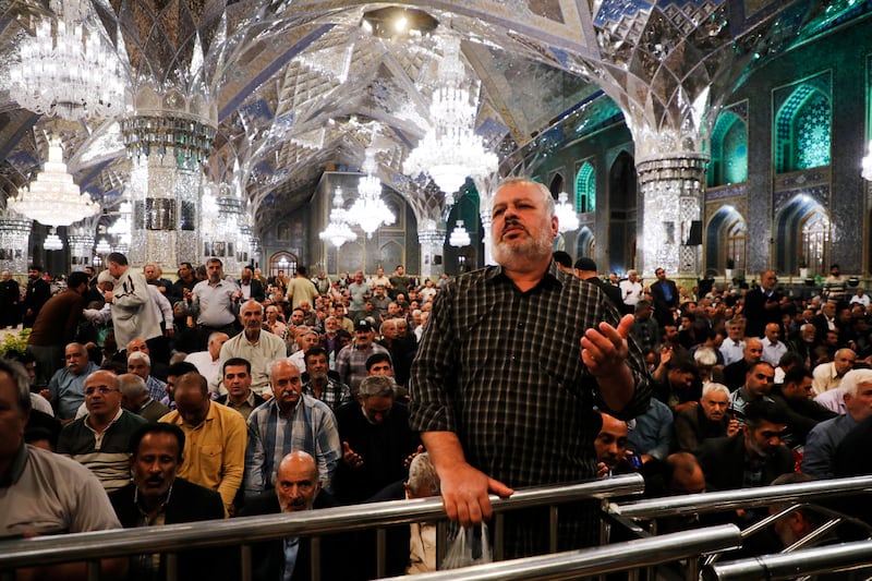 Iranian pilgrims pray for President Ebrahim Raisi at Imam Reza Shrine in the city of Mashhad (Mohammad Hasan Salavati/Shahraranews via AP)
