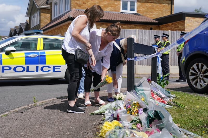 Family and friends left floral tributes and cards at Ashlyn Close, where Carol, Hannah and Louise Hunt were found fatally injured