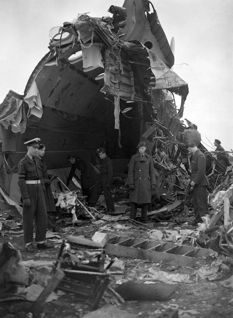 Royal Air Force officers search the wreckage of the Tudor V plane which crashed into a field in Sigingstone, Wales