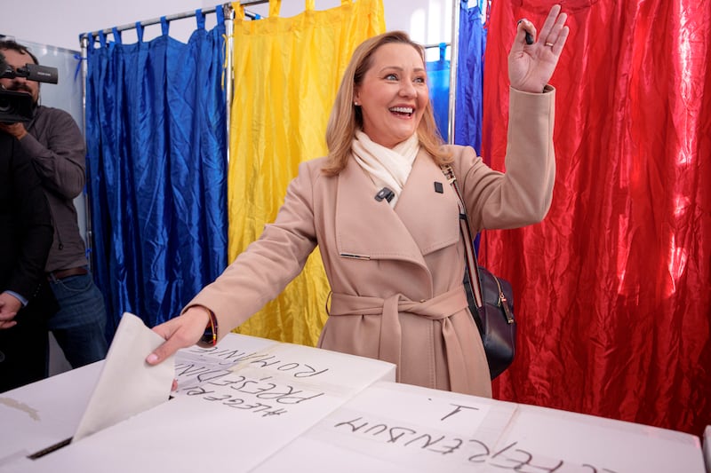 Elena Lasconi, the Save Romania Union candidate, smiles and waves while casting her ballot in Bucharest (Andreea Alexandru/AP)