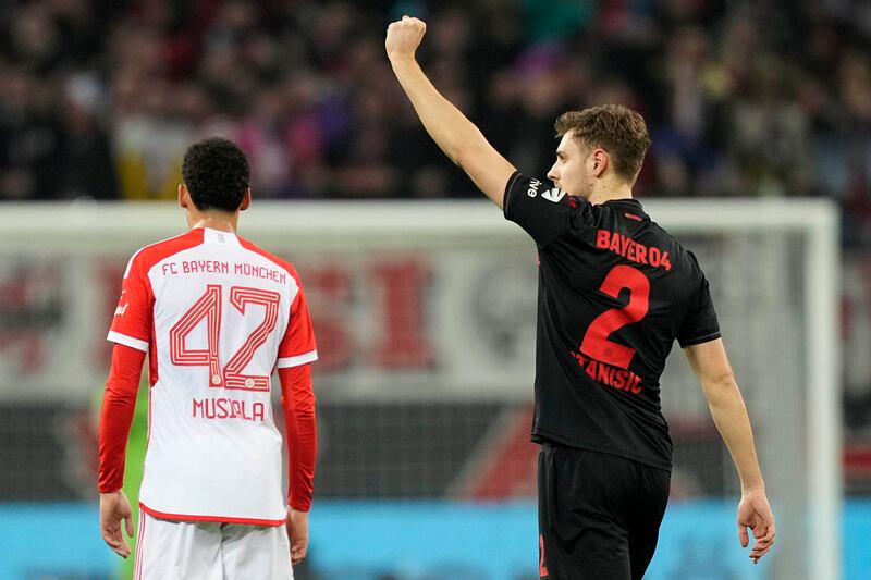 Josip Stanisic, on loan from Bayern, celebrates after scoring the opening goal against his parent club (Martin Meissner/AP)