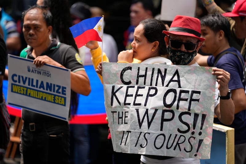 Filipino fishermen and activists held slogans as part of a protest against alleged Chinese aggression in the disputed South China Sea during a rally in front of the Chinese consulate (Aaron Favila/AP)