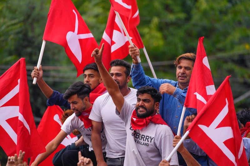 Supporters of the National Conference party in Srinagar shout slogans as they celebrate early leads in the election for a local government in Indian-controlled Kashmir (Dar Yasin/AP)