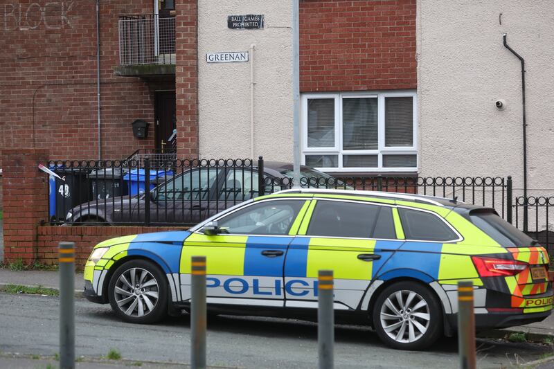 A police car parked outside a building in west Belfast