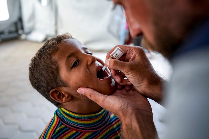 A health worker administers a polio vaccine to a child at a hospital in Deir al-Balah, central Gaza Strip (Abdel Kareem Hana/AP)