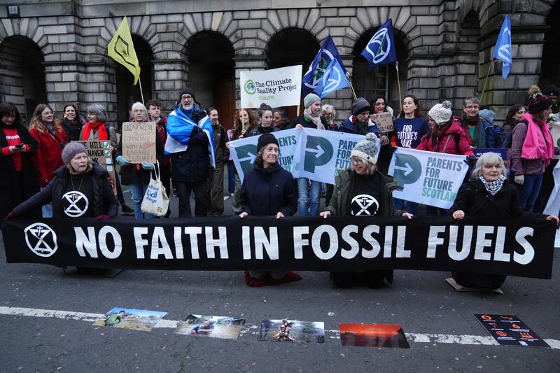 Climate activists from Greenpeace and Uplift during a demonstration outside court ahead of the hearing