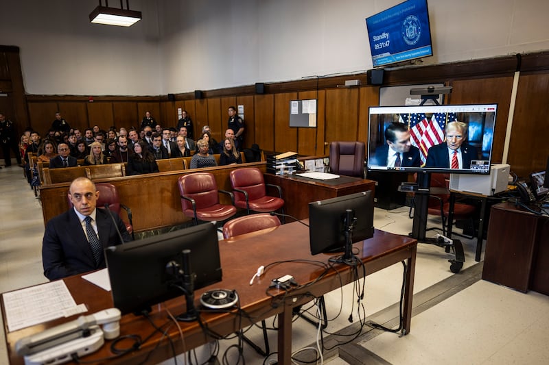 Lawyer Emil Bove, left, listens as lawyer Todd Blanche and President-elect Donald Trump, seen on a television screen, appear virtually for the sentencing in a New York court (Jabin Botsford/The Washington Post via AP)