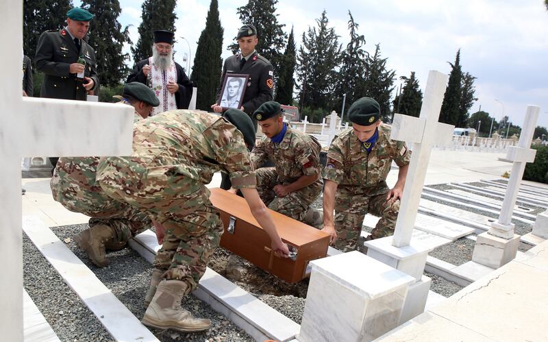 Soldiers help inter the remains of six Greek soldiers at the Tomb of Makedonitissa in Nicosia (Philippos Christou/AP)