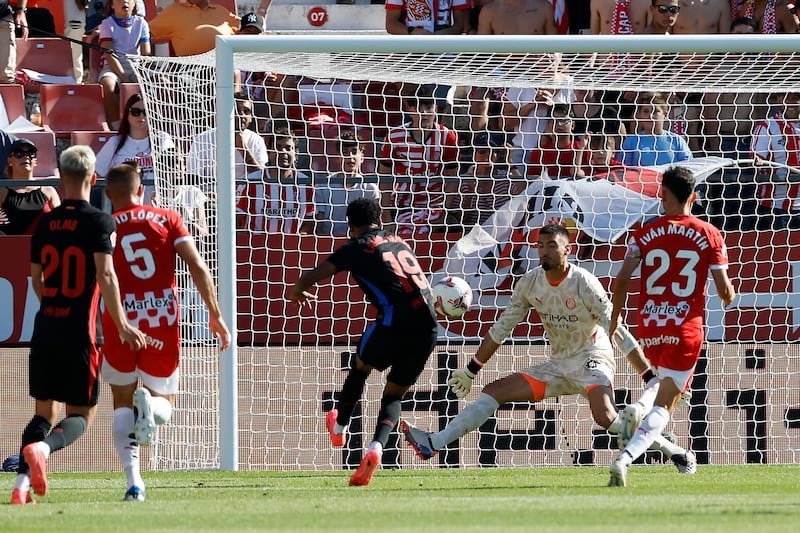 Lamine Yamal, centre left, scores Barcelona’s first goal against Girona (Joan Monfort/AP)