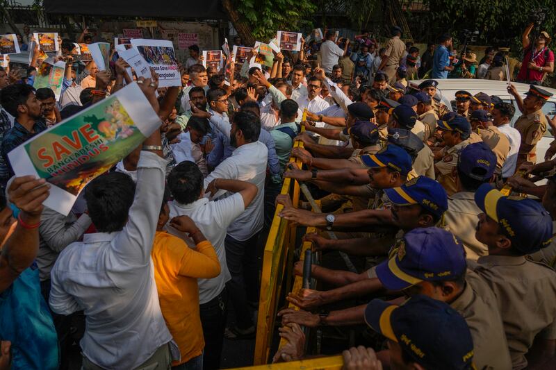 Members of Vishwa Hindu Parishad shout slogans as they are stopped by police during a protest outside the Bangladesh High Commission in Mumbai, India (Rafiq Maqbool/AP)