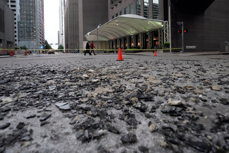 Broken glass covers a street in Houston (David J Phillip/AP)