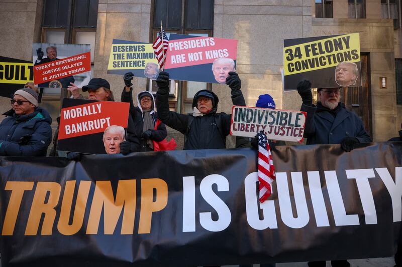 Demonstrators outside Manhattan criminal court before the start of sentencing in President-elect Donald Trump’s hush money case in New York (Yuki Iwamura/AP)